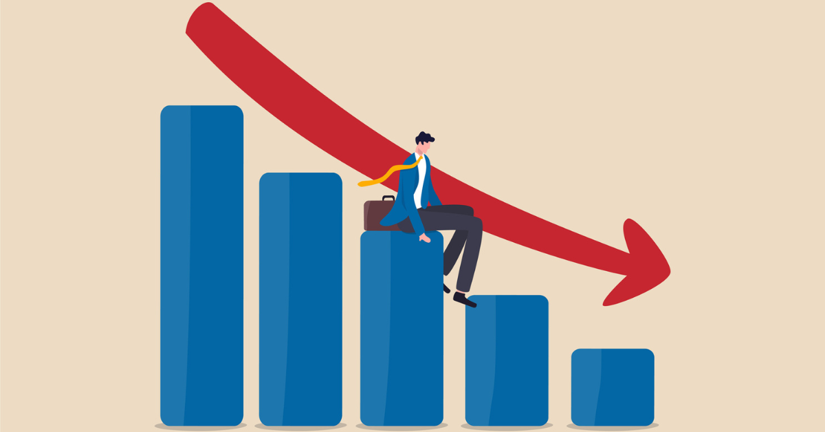 An illustration of a businessman in a black and blue suit sitting on a blue graph. A red arrow is pointing down towards the bottom bar. 